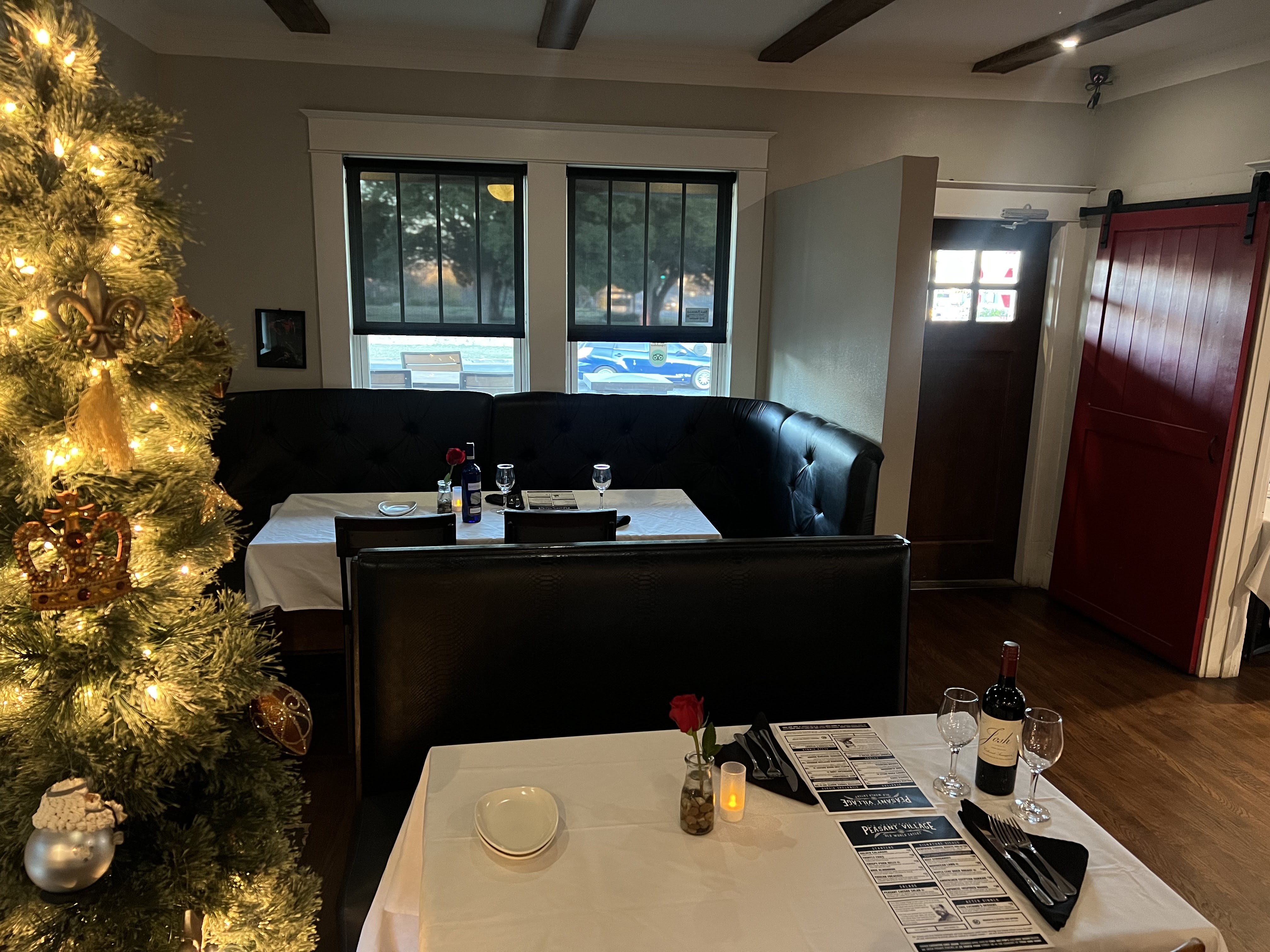 Intimate table setting at Peasant Village with white linens and wine